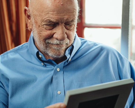 man looking at photo album