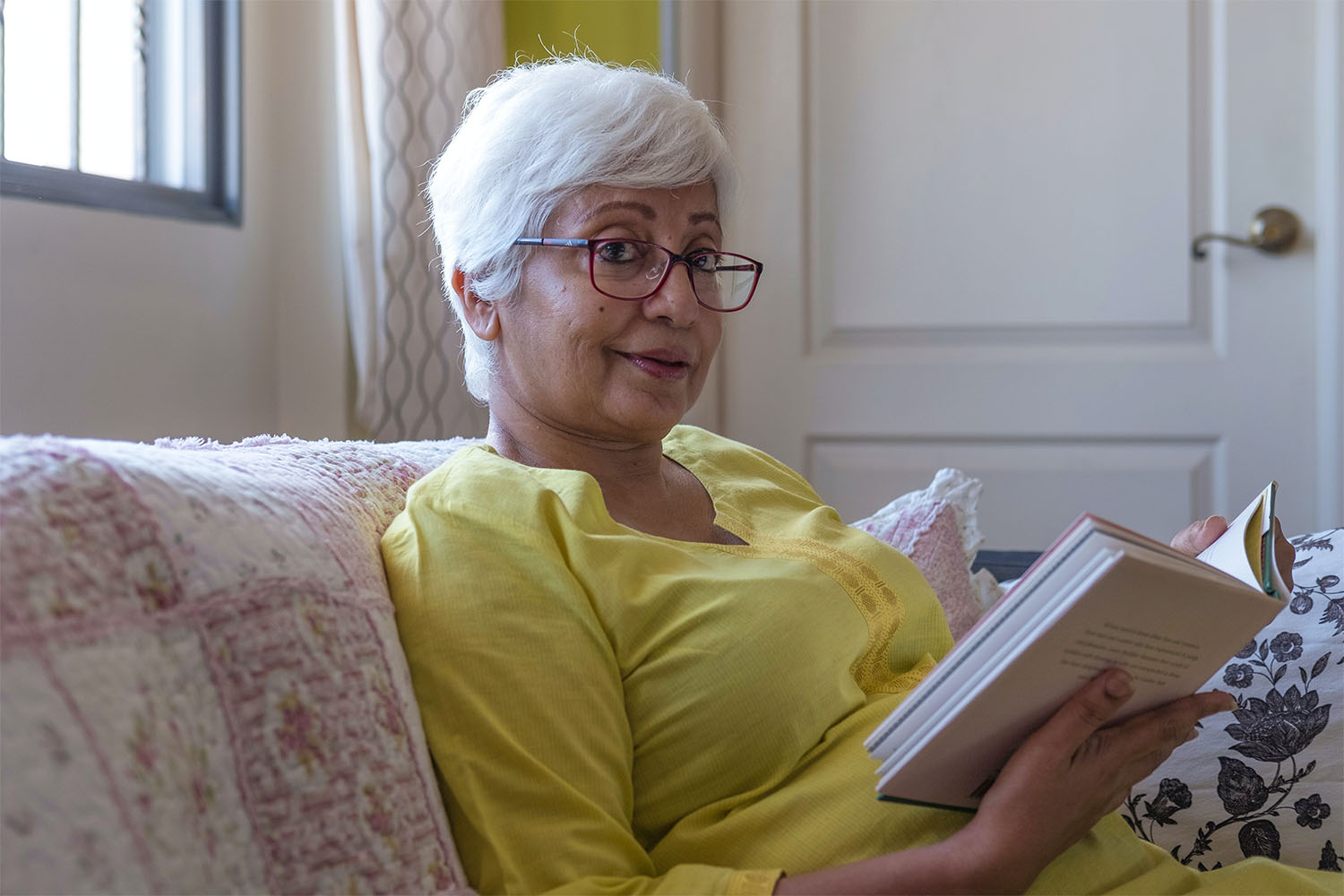 lady with white hair reading a book