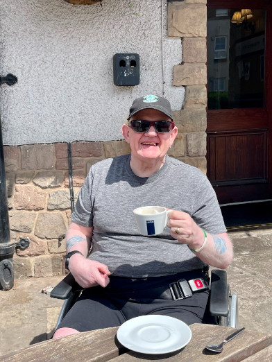 Resident enjoying a coffee outside
