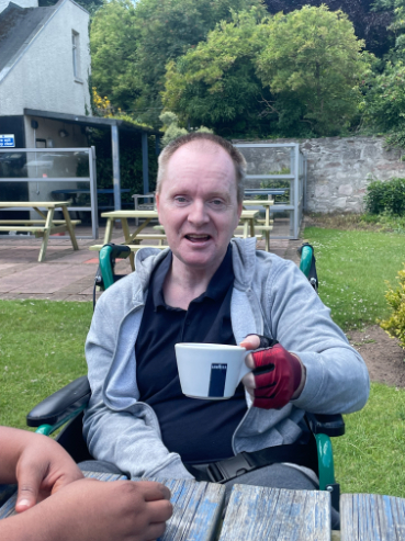 Resident having a coffee outside