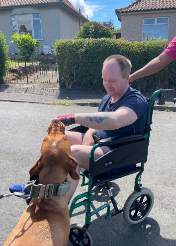 resident in wheelchair with dog