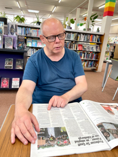 resident reading the newspaper