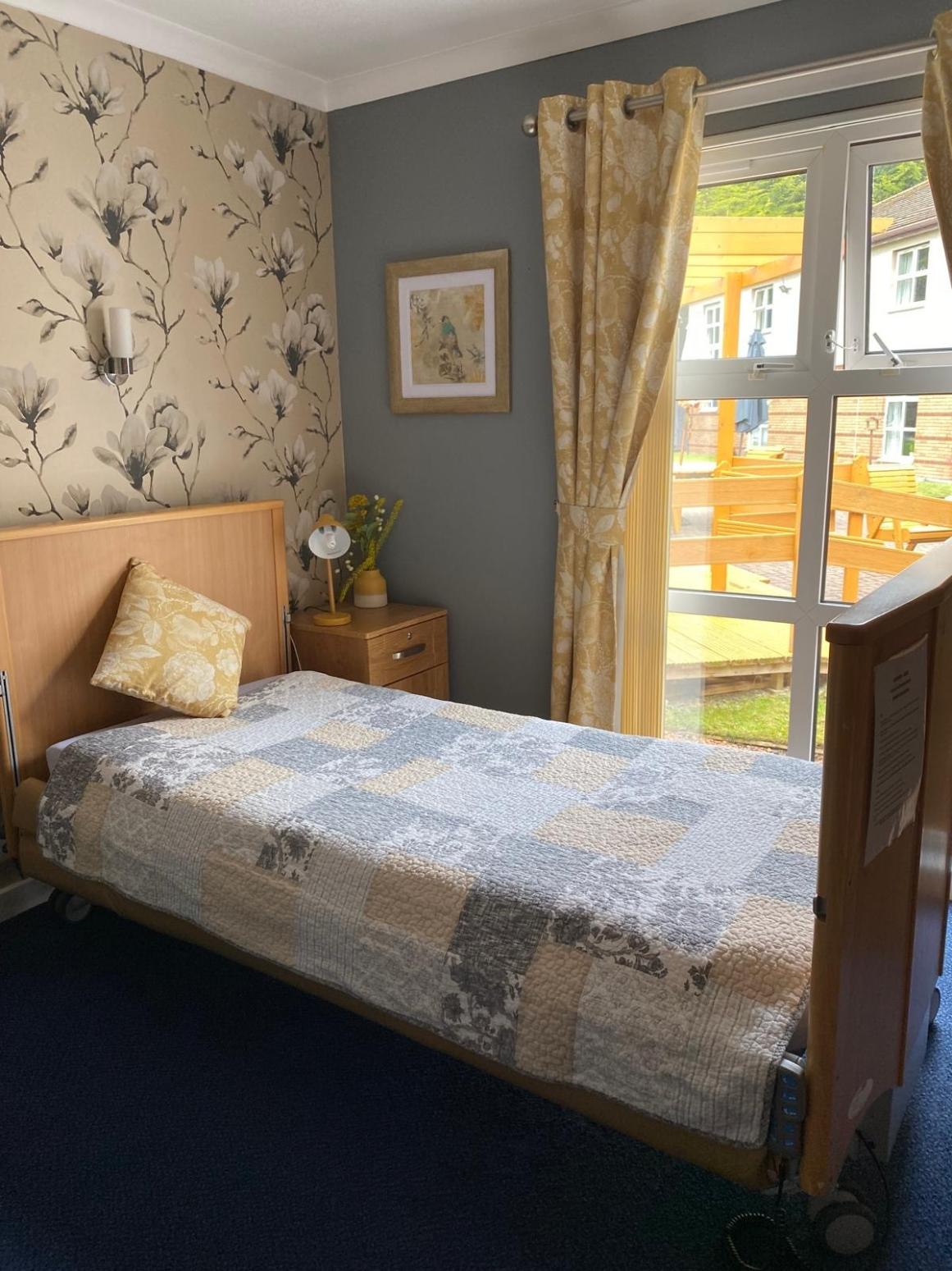 care home bedroom with grey adn yellow decoration